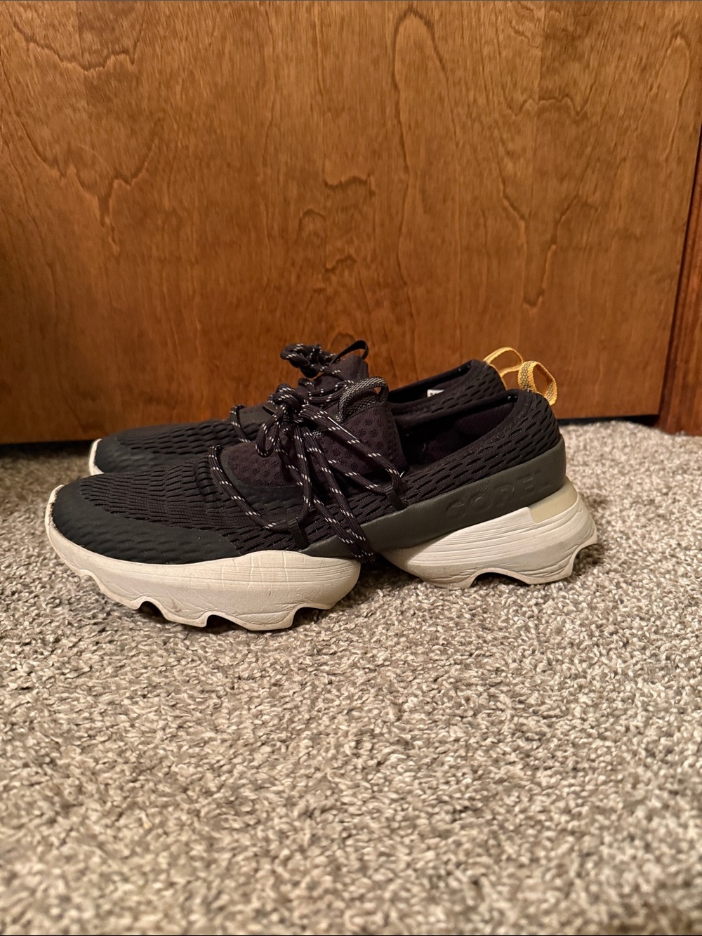 Sorel Black and White Slip-On Sneakers with Yellow Pull Tab